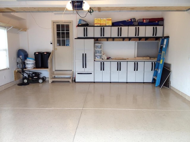 garage with a garage door opener and white fridge