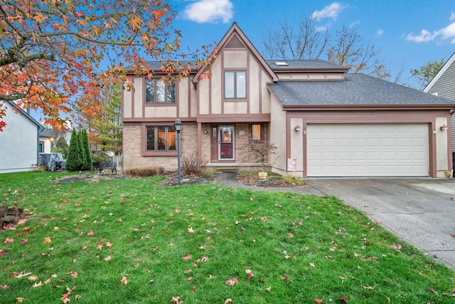 tudor home with a garage and a front yard