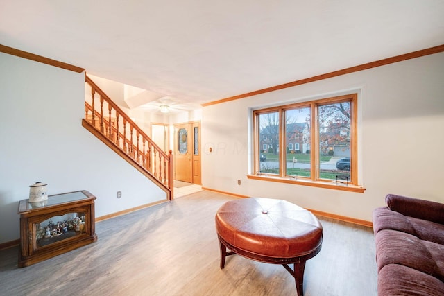 living room with crown molding and hardwood / wood-style floors