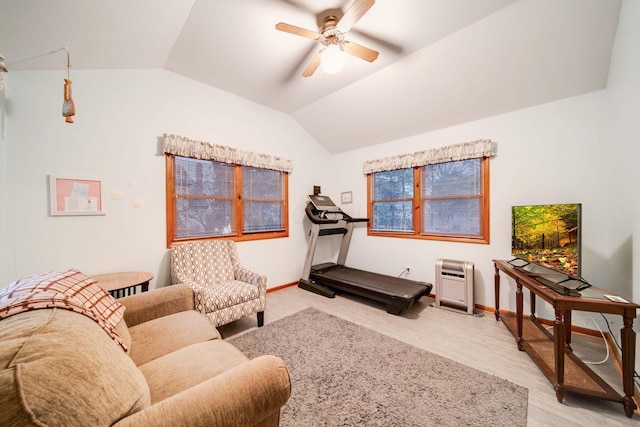 living room featuring lofted ceiling, light wood-type flooring, and ceiling fan