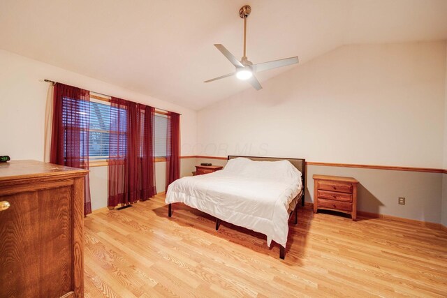 bedroom featuring lofted ceiling, ceiling fan, and light hardwood / wood-style flooring