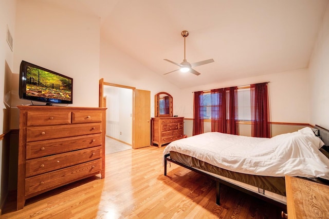 bedroom featuring high vaulted ceiling, light hardwood / wood-style floors, and ceiling fan