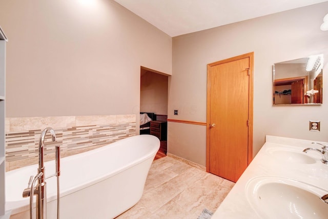 bathroom featuring vanity, a bathing tub, and tile walls