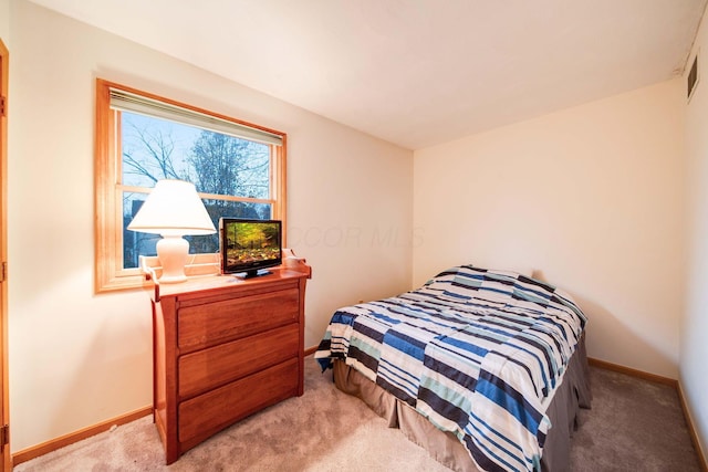 bedroom featuring light colored carpet