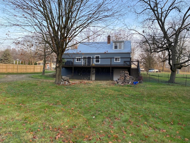 back of house featuring a deck and a yard