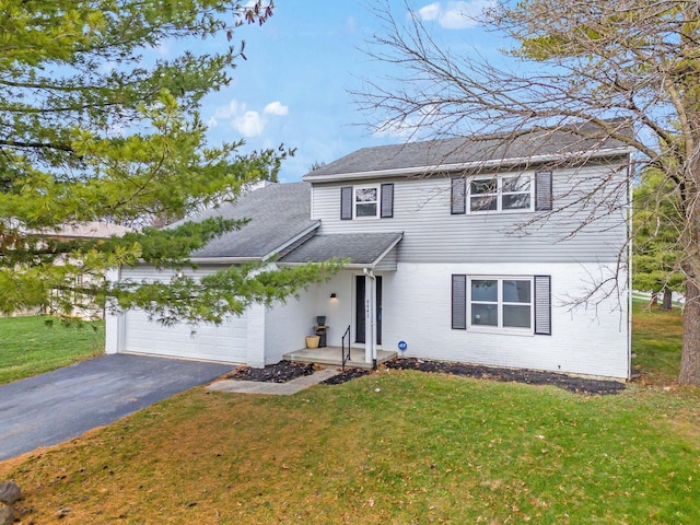 view of front property featuring a front yard and a garage