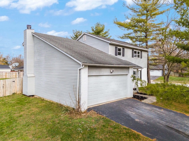 view of side of home with a lawn and a garage