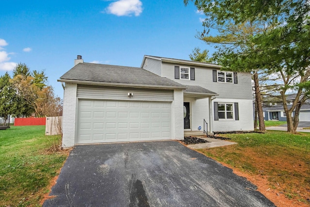 view of front property featuring a garage and a front lawn