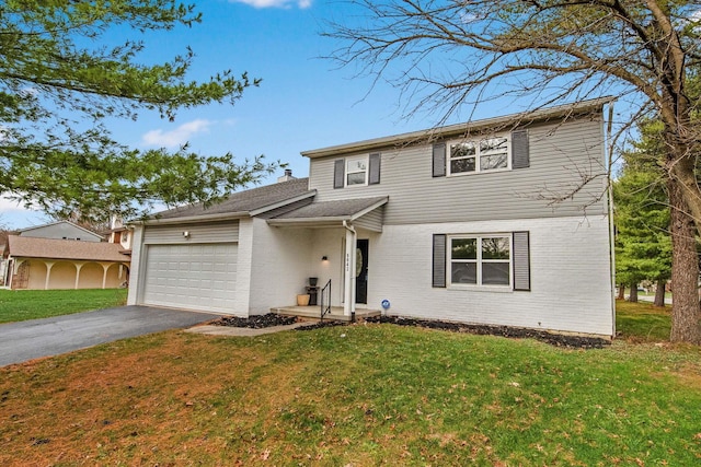 front facade featuring a garage and a front lawn