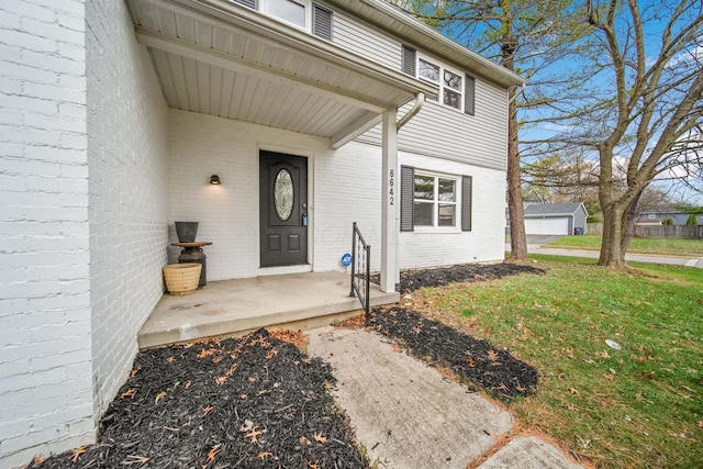 doorway to property with a yard