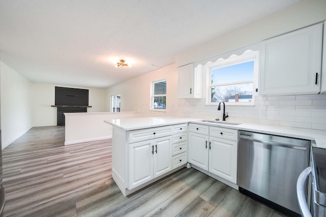 kitchen with white cabinets, sink, kitchen peninsula, and stainless steel appliances