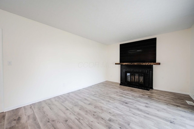 unfurnished living room with light hardwood / wood-style floors