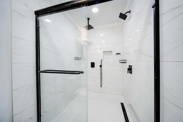 bathroom featuring a shower with shower door and ornamental molding