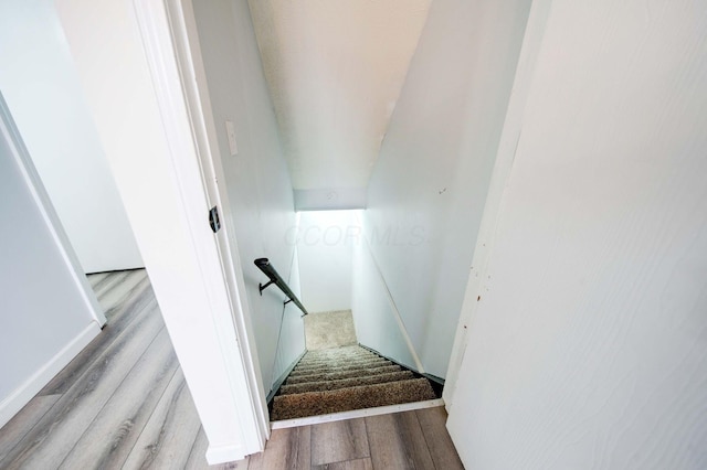 stairway featuring hardwood / wood-style flooring