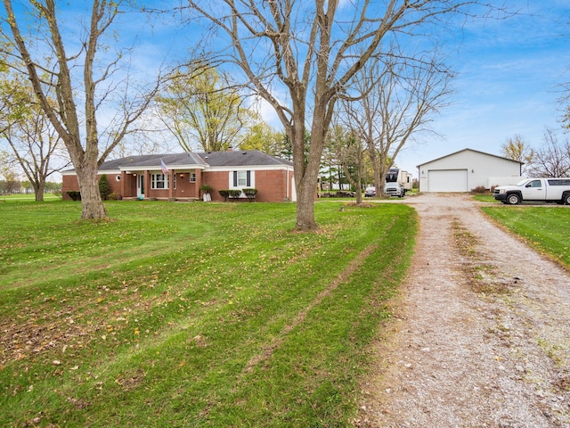 view of front of house featuring a garage, an outbuilding, and a front yard