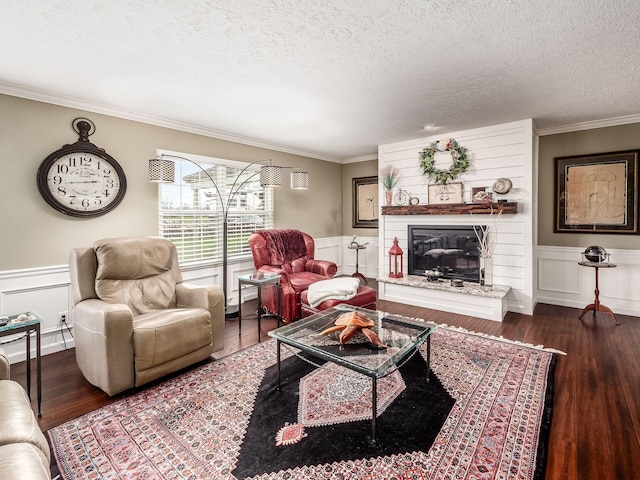 living room with a textured ceiling, dark hardwood / wood-style floors, and ornamental molding