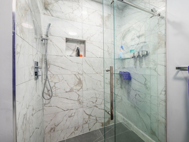 bathroom featuring a shower with door