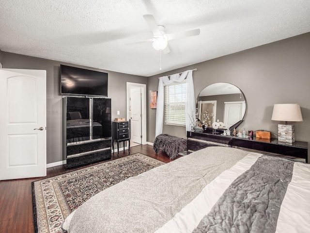 bedroom featuring a textured ceiling, ceiling fan, and dark hardwood / wood-style floors