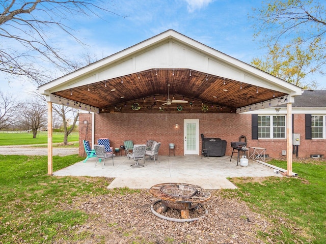 exterior space with an outdoor fire pit and a grill