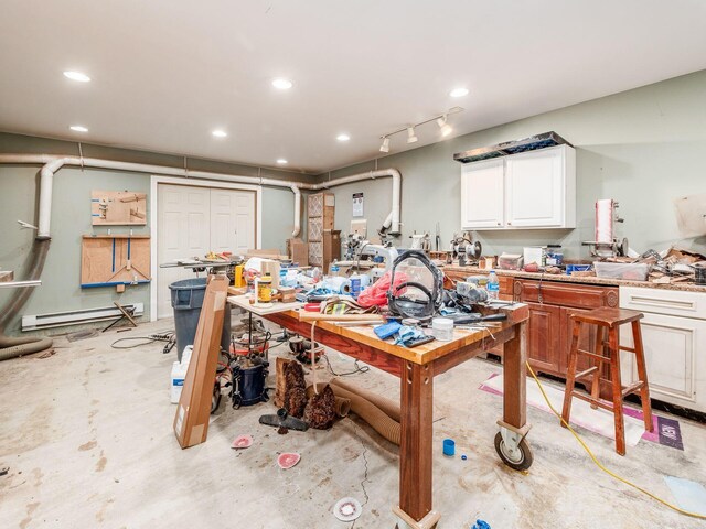 interior space with a workshop area and a baseboard radiator