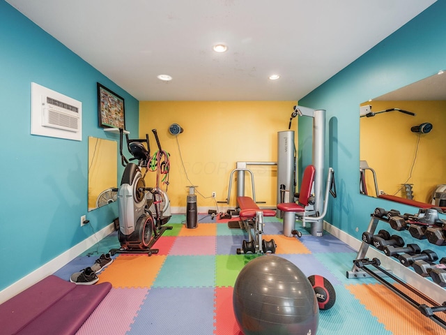 workout area featuring an AC wall unit