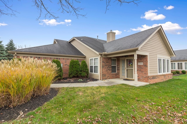 rear view of property featuring a yard