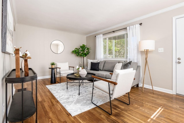 living room featuring wood-type flooring and ornamental molding