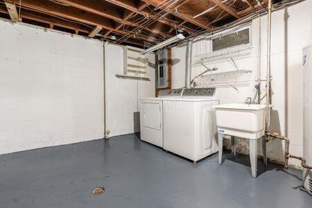 basement with washing machine and dryer and sink