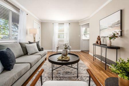 living room featuring hardwood / wood-style flooring and crown molding