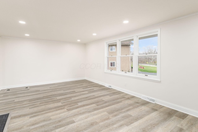 unfurnished room featuring crown molding and light hardwood / wood-style flooring