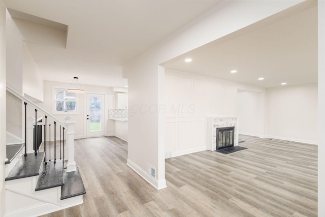 unfurnished living room with light hardwood / wood-style floors and a fireplace