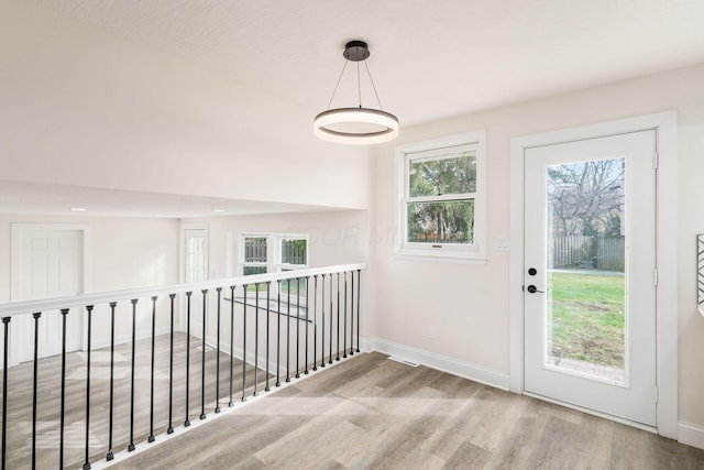 hall featuring hardwood / wood-style flooring and a textured ceiling