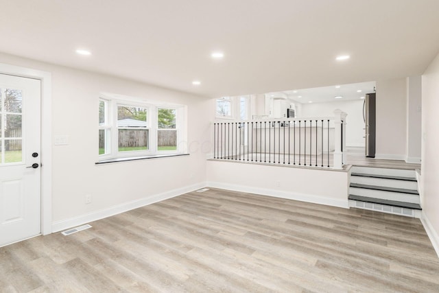 interior space with light hardwood / wood-style floors and a wealth of natural light