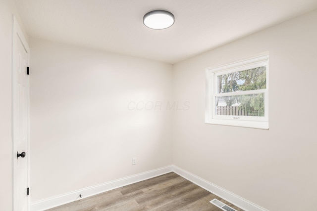 empty room featuring hardwood / wood-style flooring