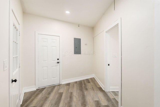 hallway with electric panel and hardwood / wood-style flooring