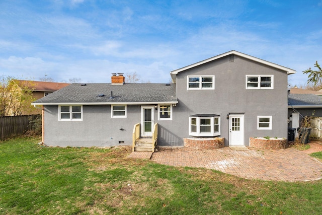 back of house with a lawn and a patio