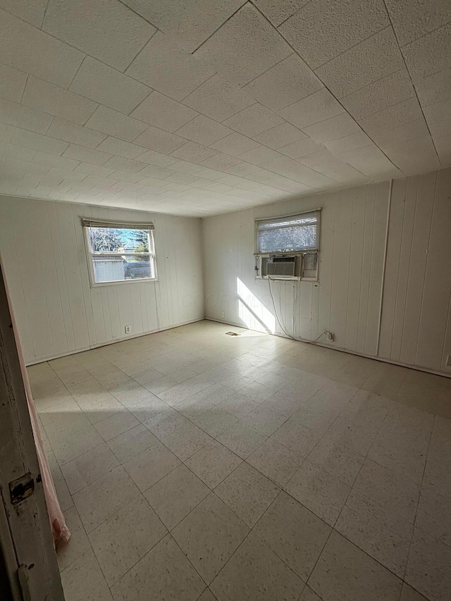 empty room with wood walls and cooling unit