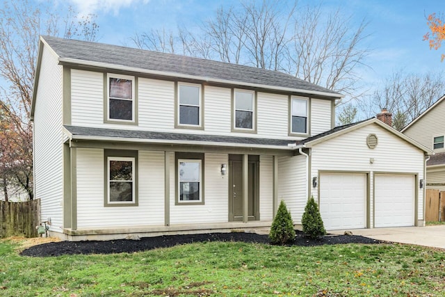 view of property with a front yard and a garage