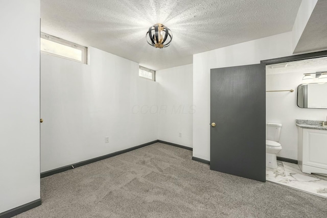 basement with light carpet and a textured ceiling