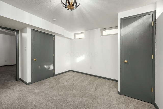 unfurnished bedroom featuring light colored carpet and a textured ceiling