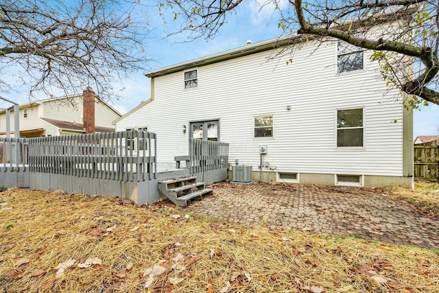 rear view of house featuring a patio, central AC unit, and a wooden deck