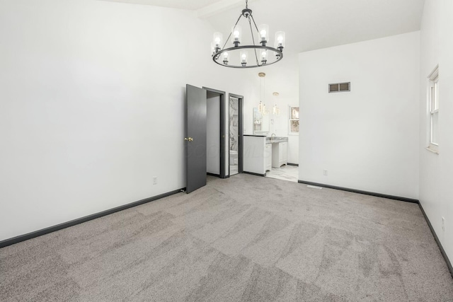 interior space with light carpet, high vaulted ceiling, and a chandelier