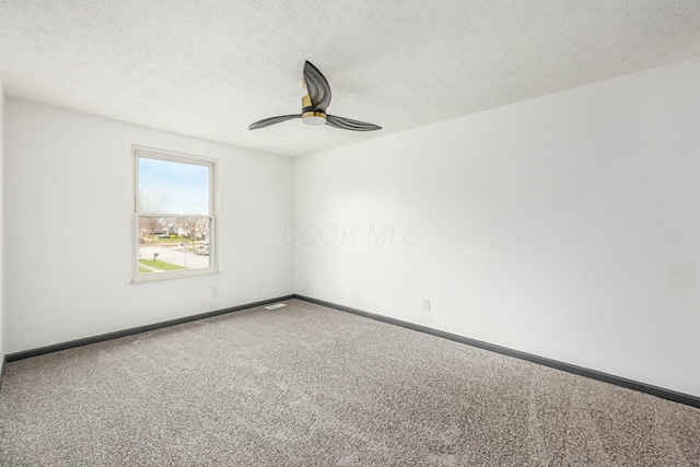 carpeted empty room featuring ceiling fan and a textured ceiling