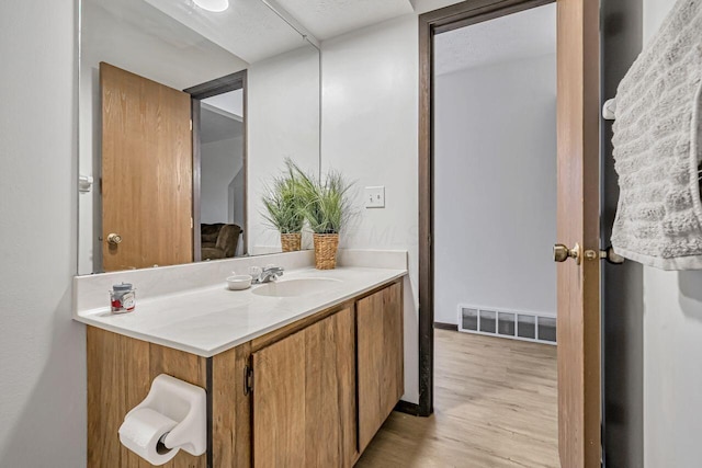 bathroom with vanity and hardwood / wood-style flooring