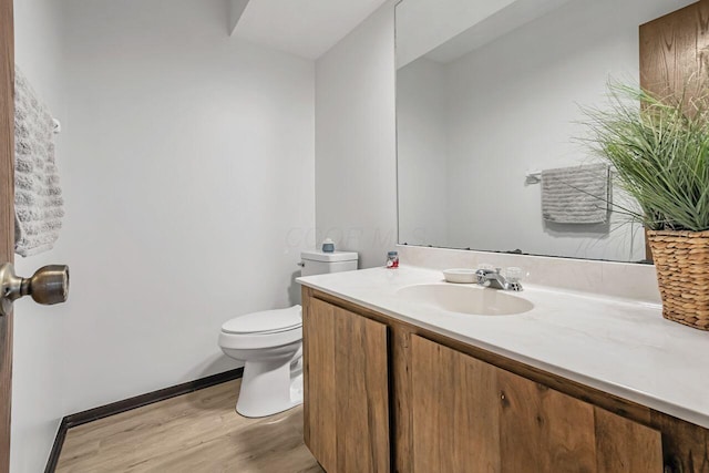 bathroom with vanity, wood-type flooring, and toilet