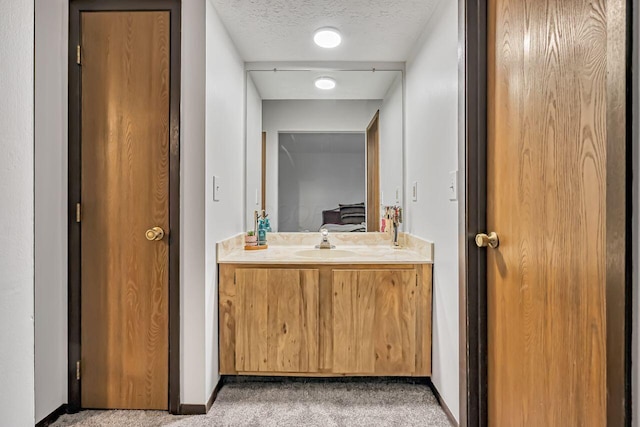 bathroom with vanity and a textured ceiling