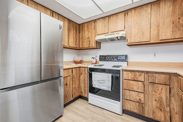 kitchen with electric stove, stainless steel fridge, and light wood-type flooring