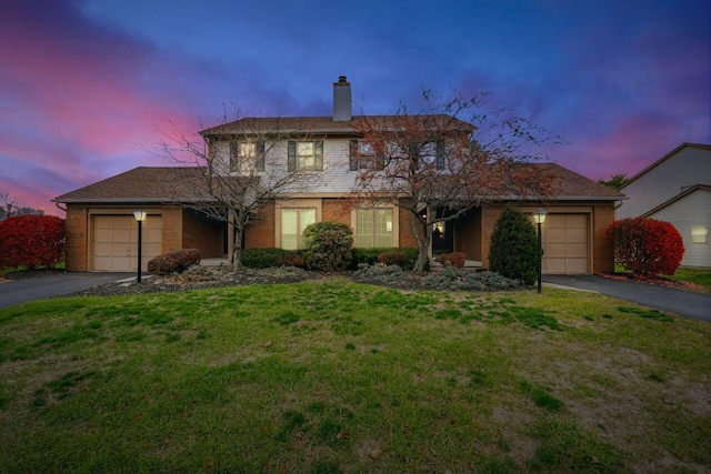 view of property featuring a yard and a garage