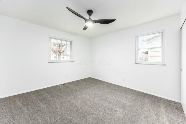 carpeted empty room featuring ceiling fan