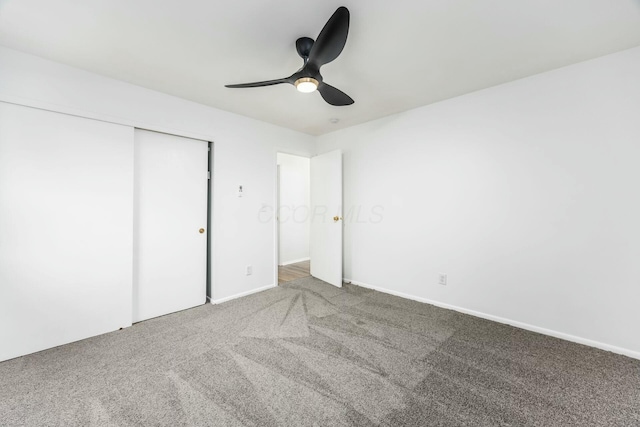 unfurnished bedroom featuring ceiling fan, carpet floors, and a closet